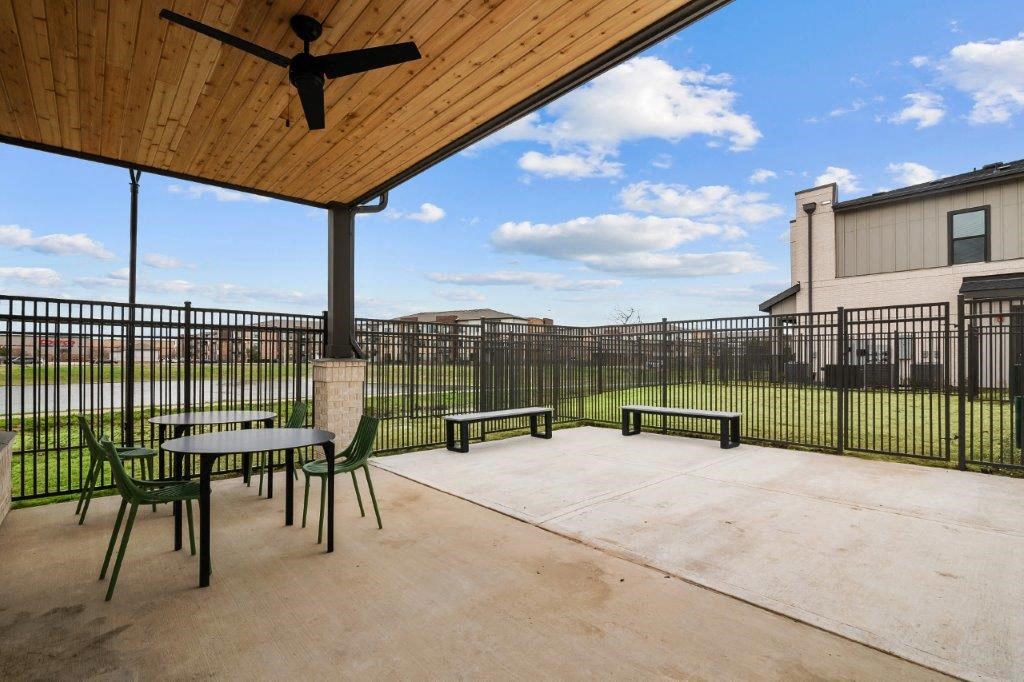 the spacious patio of our apartments with tables and chairs