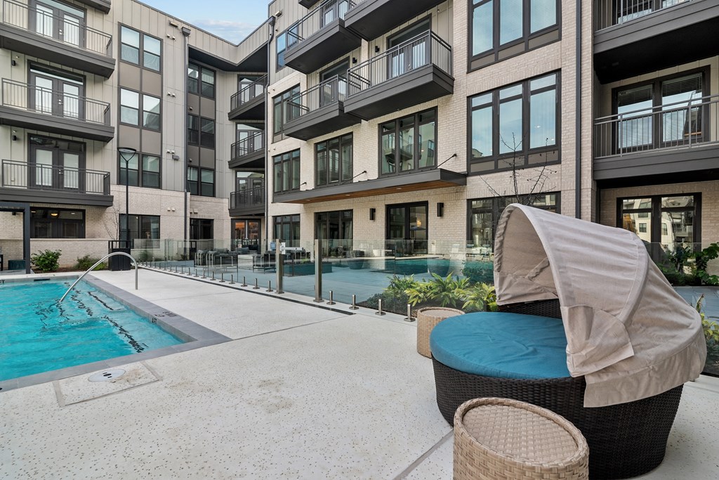 a swimming pool in front of an apartment building