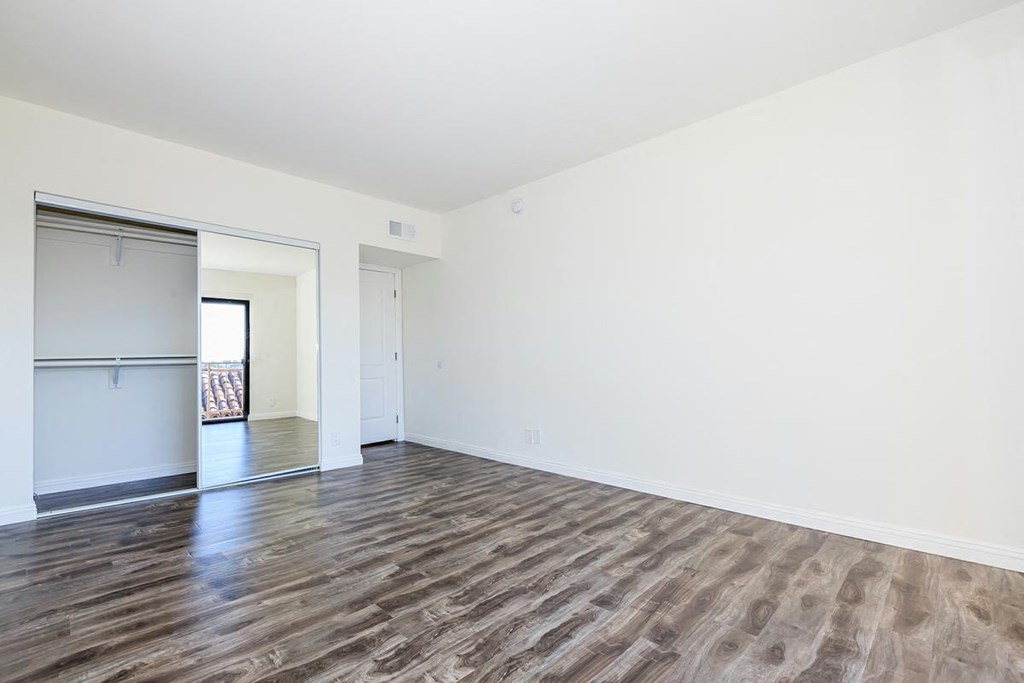 an empty living room with white walls and wood floors