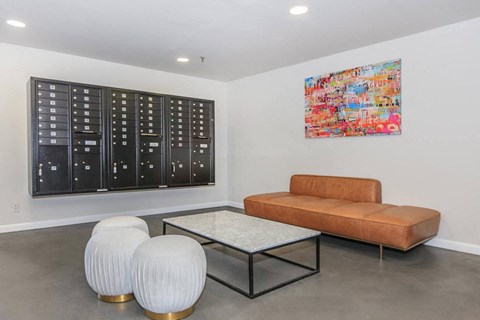 the living room has a leather couch and a coffee table