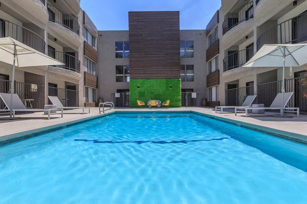 a swimming pool in front of an apartment building