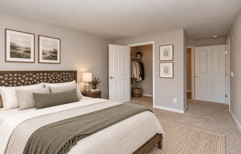 A bedroom with a large bed and a wardrobe.