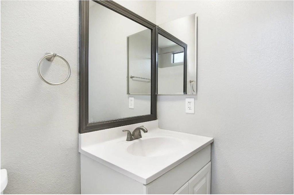 A bathroom sink with a mirror above it.