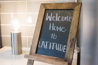 Latitude Apartments and Townhomes Welcome Home Sign