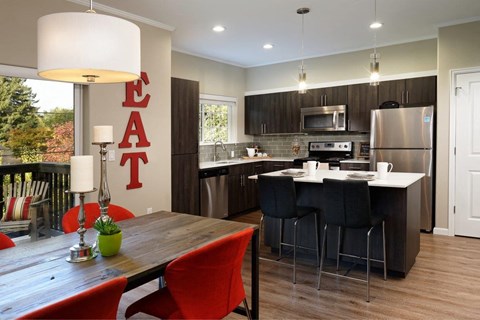 a kitchen and dining room with a table and chairs