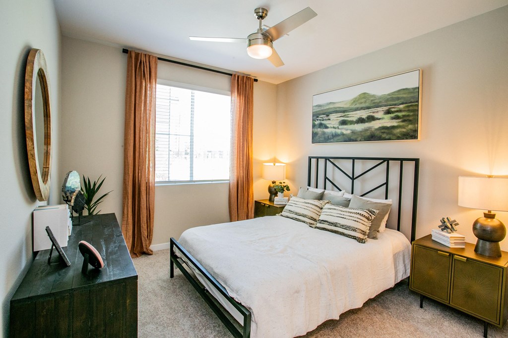 a bedroom with a bed and a ceiling fan