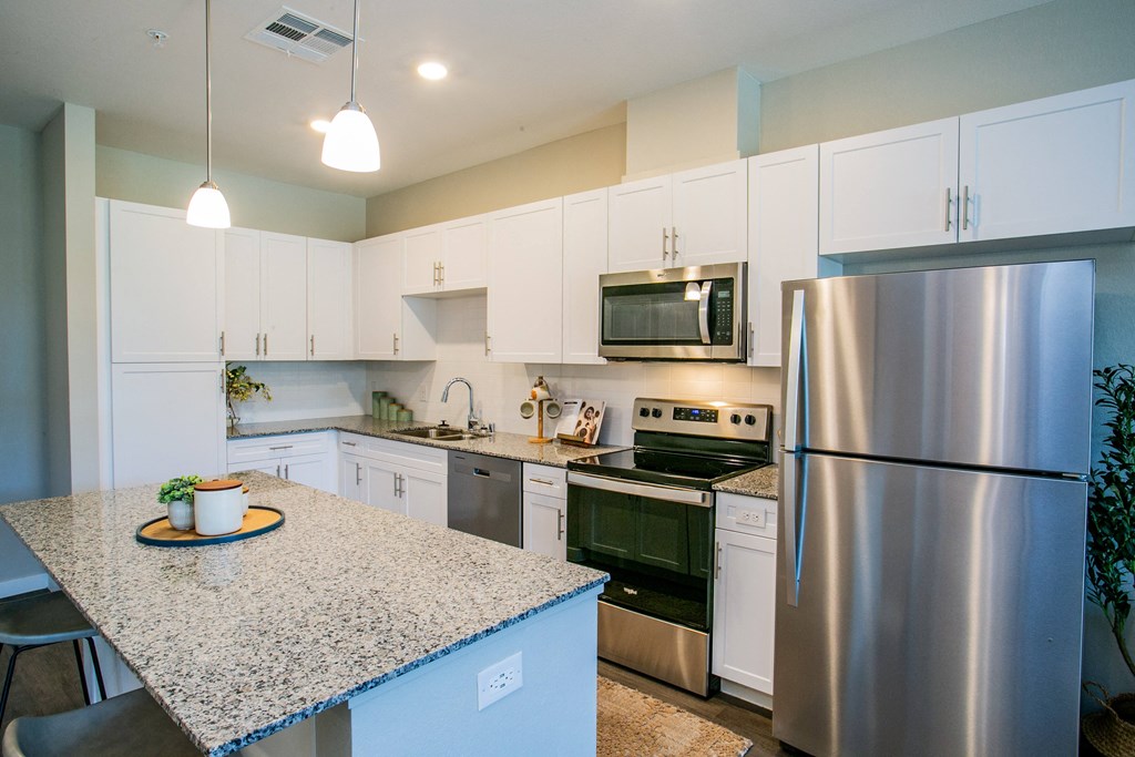 a kitchen with stainless steel appliances and granite counter tops