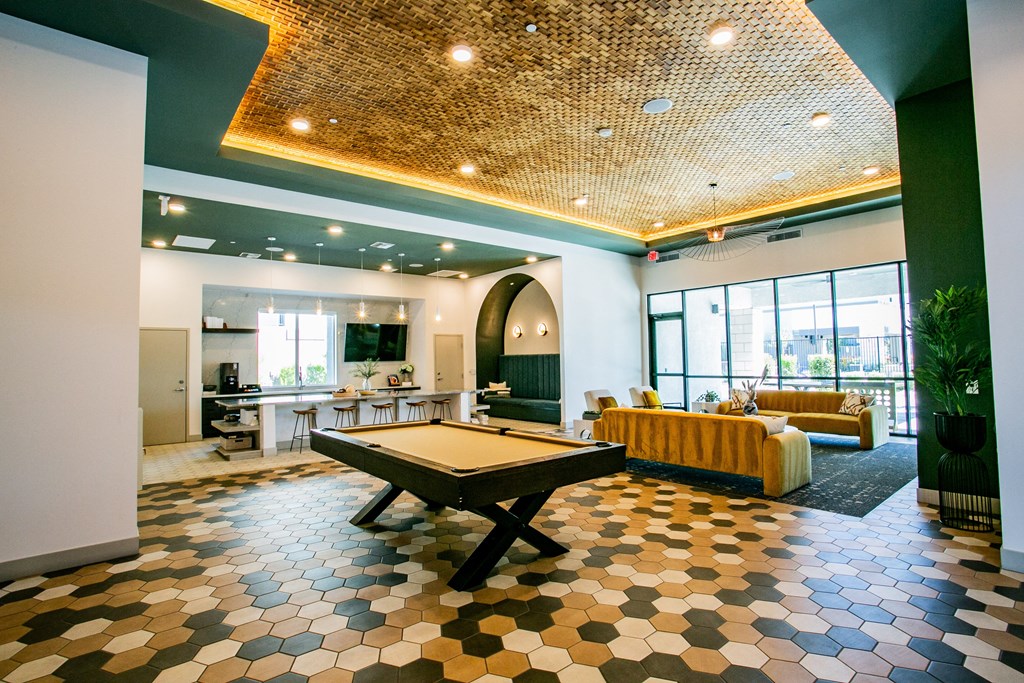 a room with a pool table in the middle of it