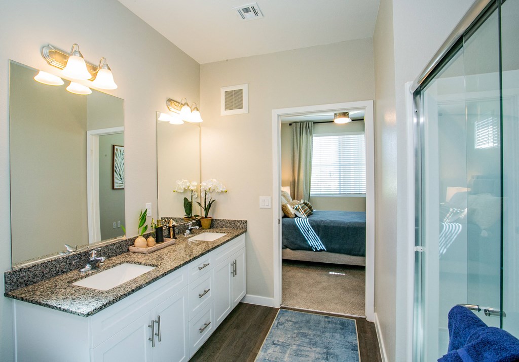 a bathroom with a shower and a sink and a mirror