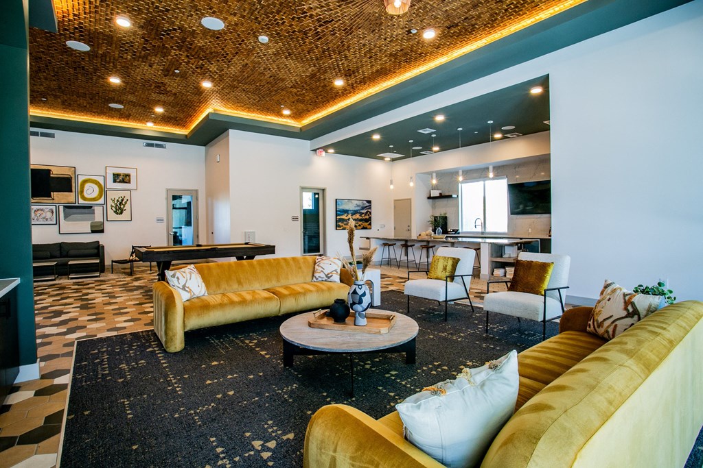 a living room with couches and chairs and a table