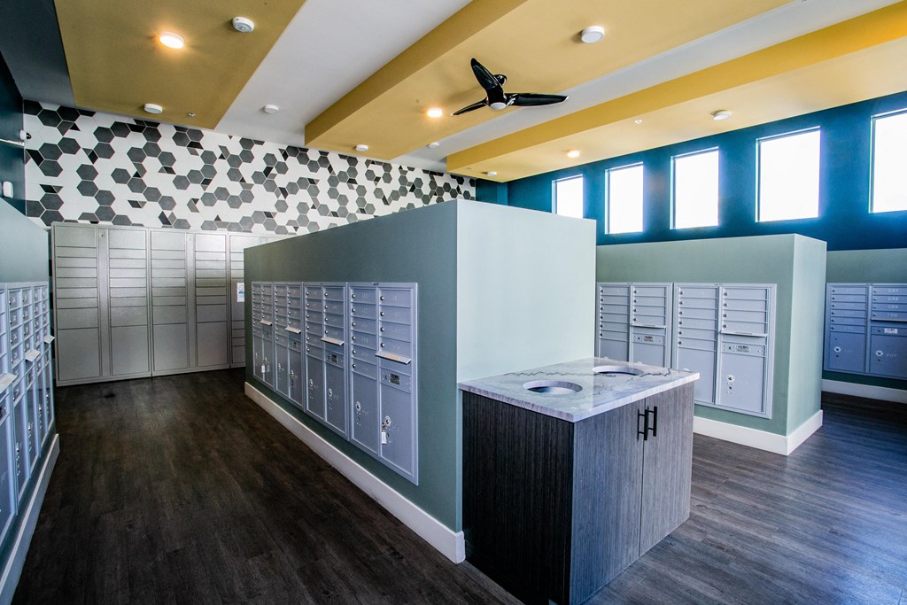 a locker room with lots of lockers and counters and a ceiling fan