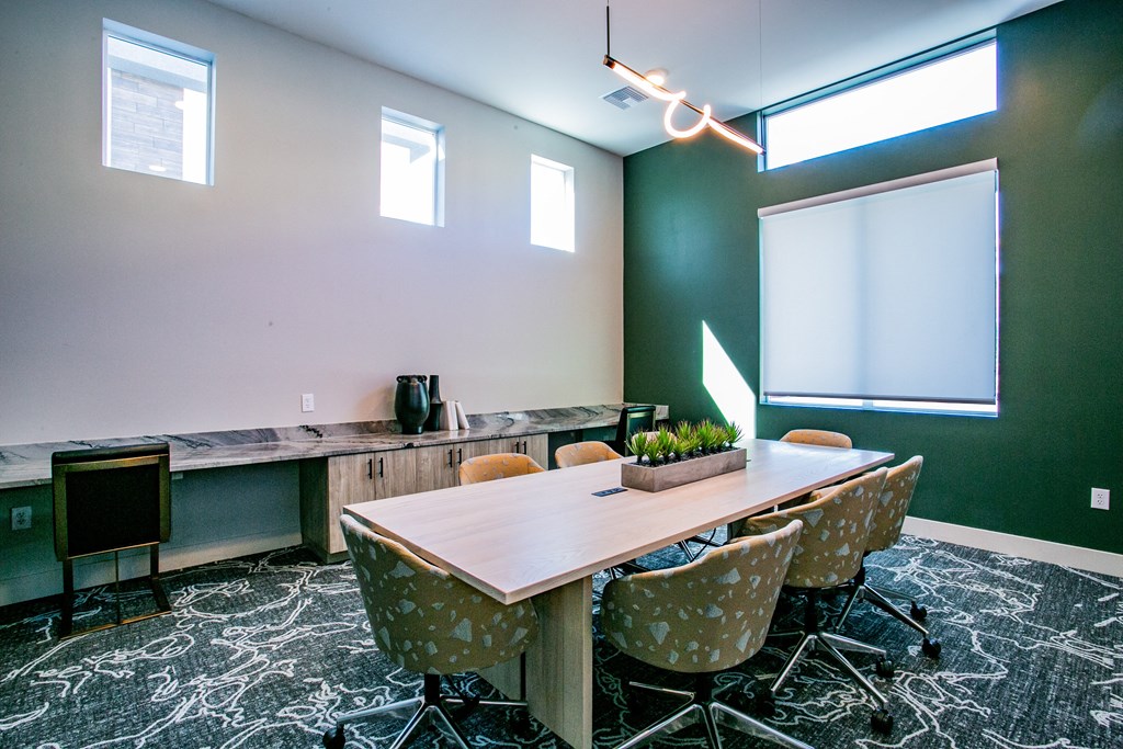 a room with tables and chairs and a rainbow colored wall