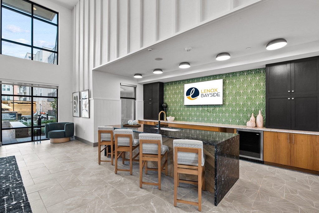 a communal kitchen and dining area in a hotel lobby