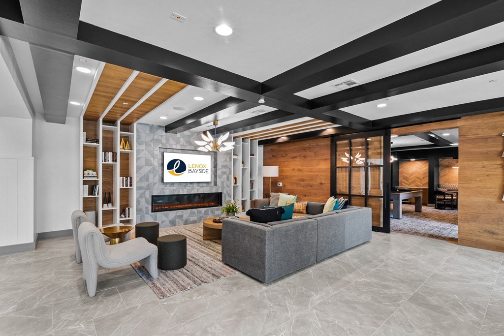 a lobby with a couch and chairs and a fireplace