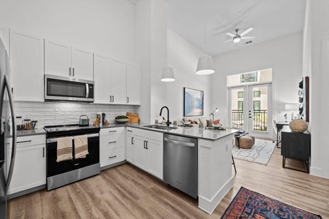 a kitchen with white cabinets and a counter top