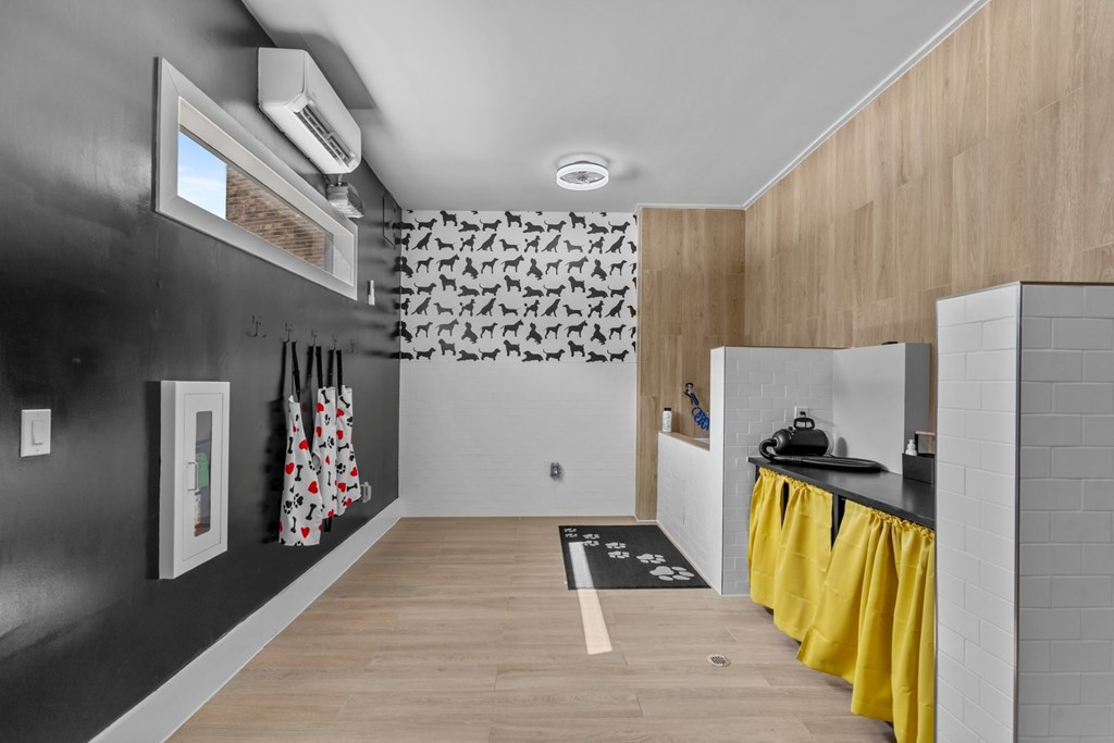 A kitchen with a black wall and yellow curtains.