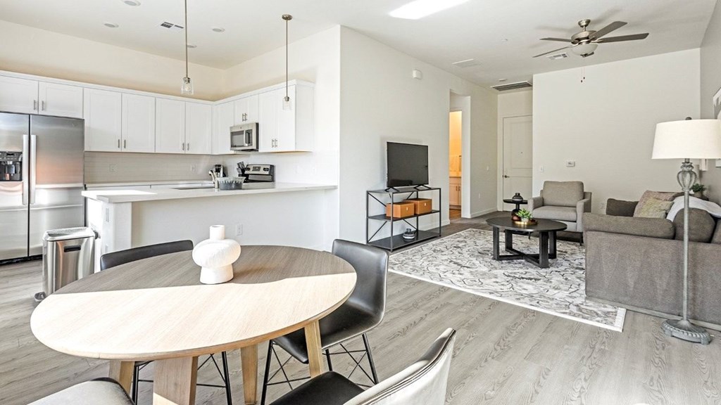 A modern kitchen with a dining table and chairs.