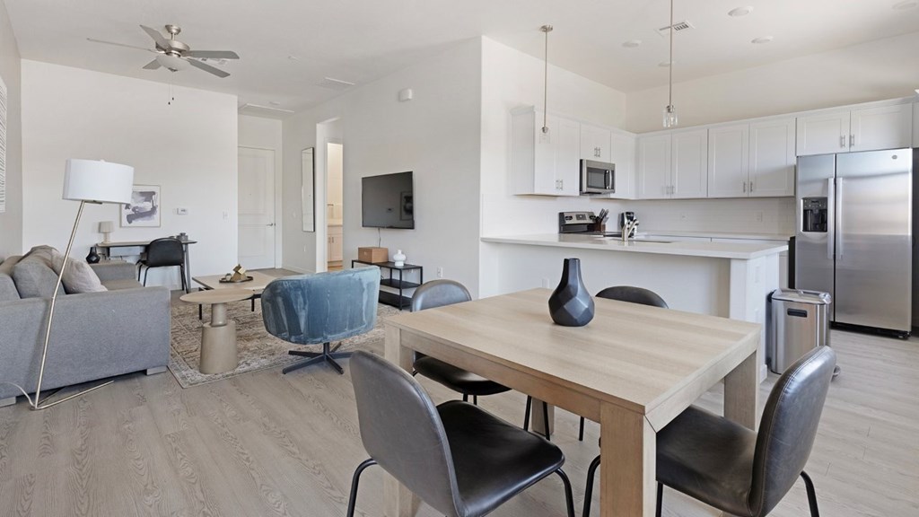 A modern dining room with a wooden table and chairs.