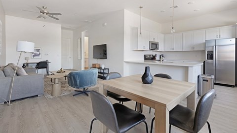 A modern dining room with a wooden table and chairs.