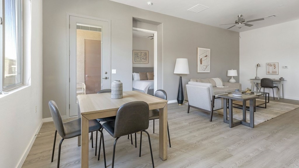 A living room with a dining table and chairs.
