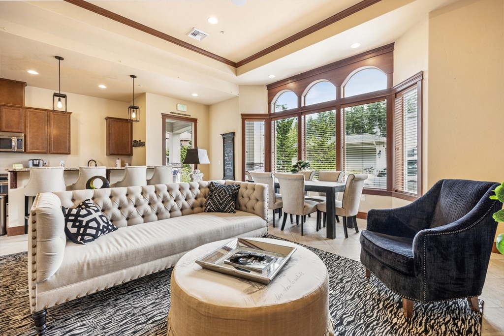 A living room with a white sofa and a black chair.