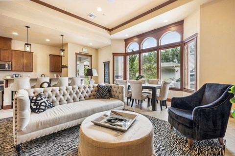 A living room with a white sofa and a black chair.