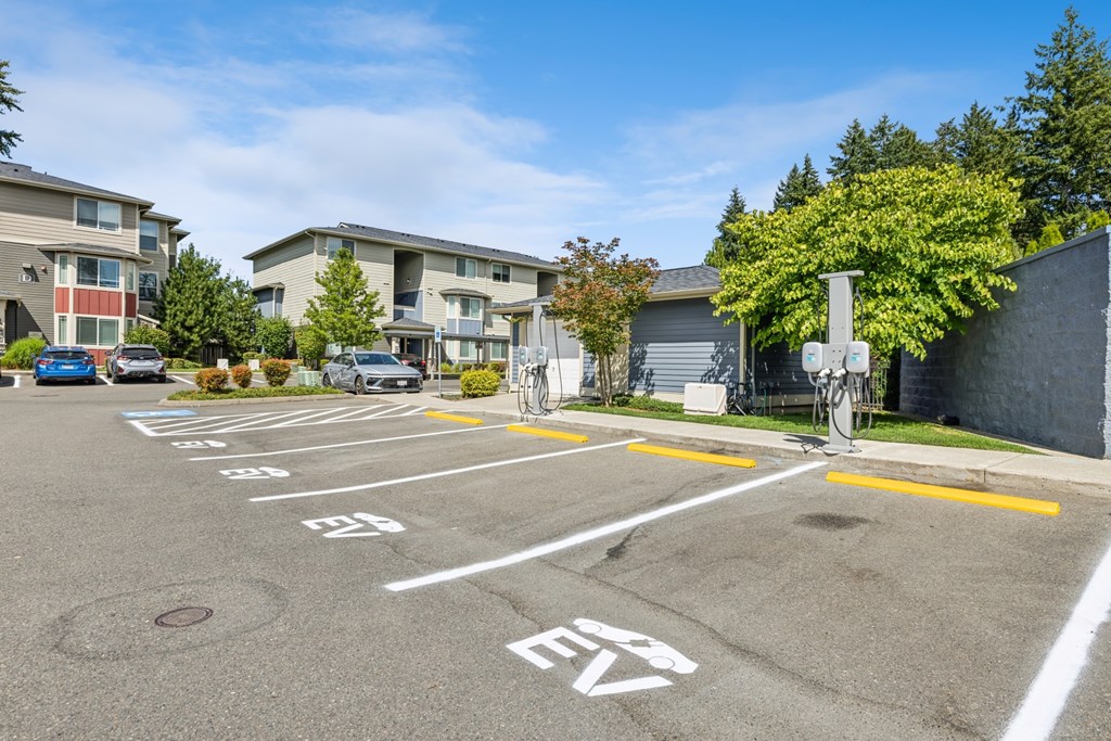 A parking lot with a bicycle rack and numbered parking spaces.