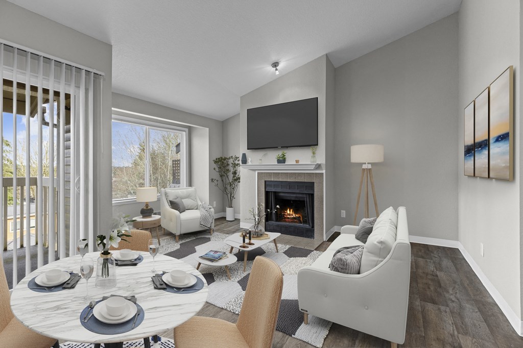 a living room with a fireplace and a table and chairs