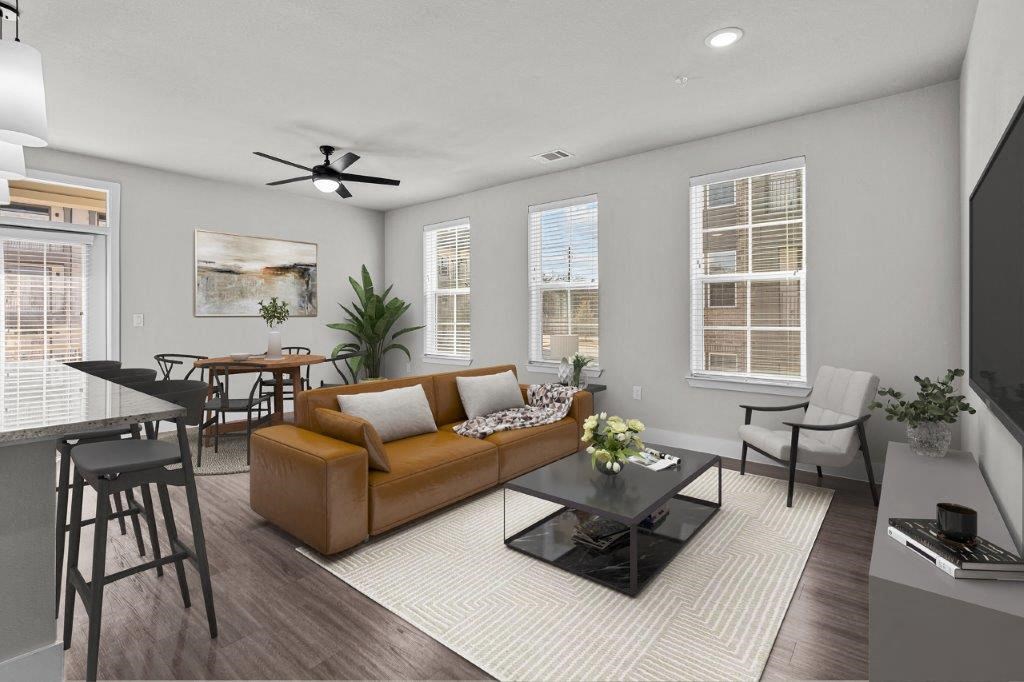 a living room with a couch and a table and chairs at Lenox Grand, Texas