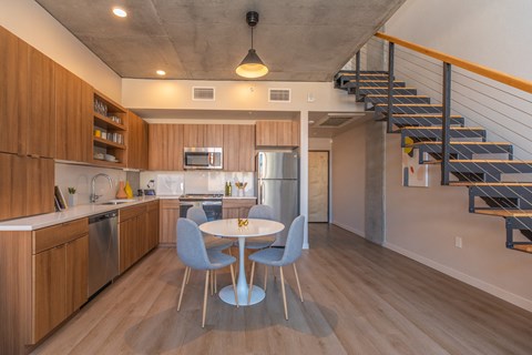A kitchen with a table and chairs in the middle of the room.