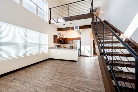 A modern living room with a staircase leading to the upper floor.