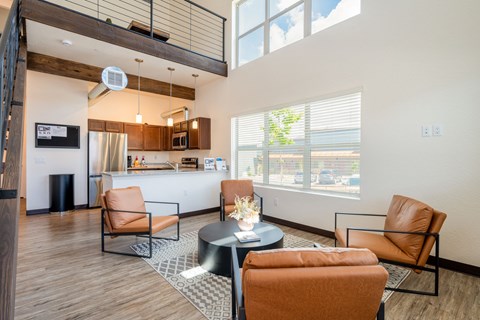 A living room with a black coffee table and orange chairs.