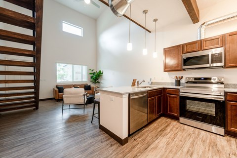A modern kitchen with wooden cabinets and a white island.