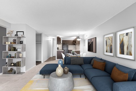 A modern living room with a grey sofa and a yellow rug.