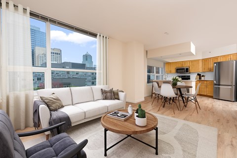 A modern living room with a white sofa and a coffee table.