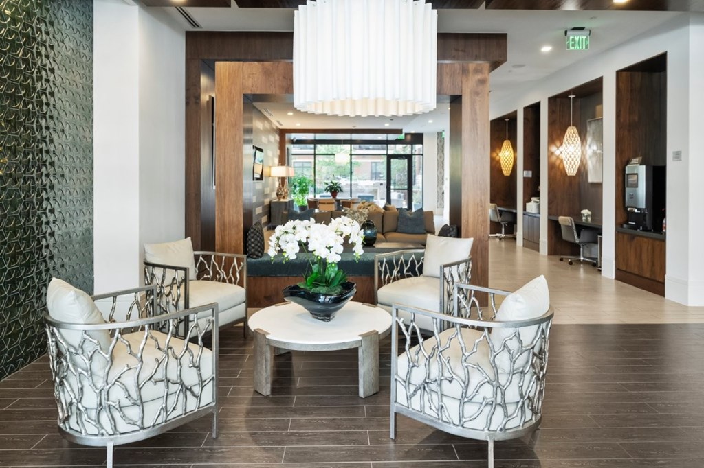 A white chair with a black and white pattern sits in a lobby.