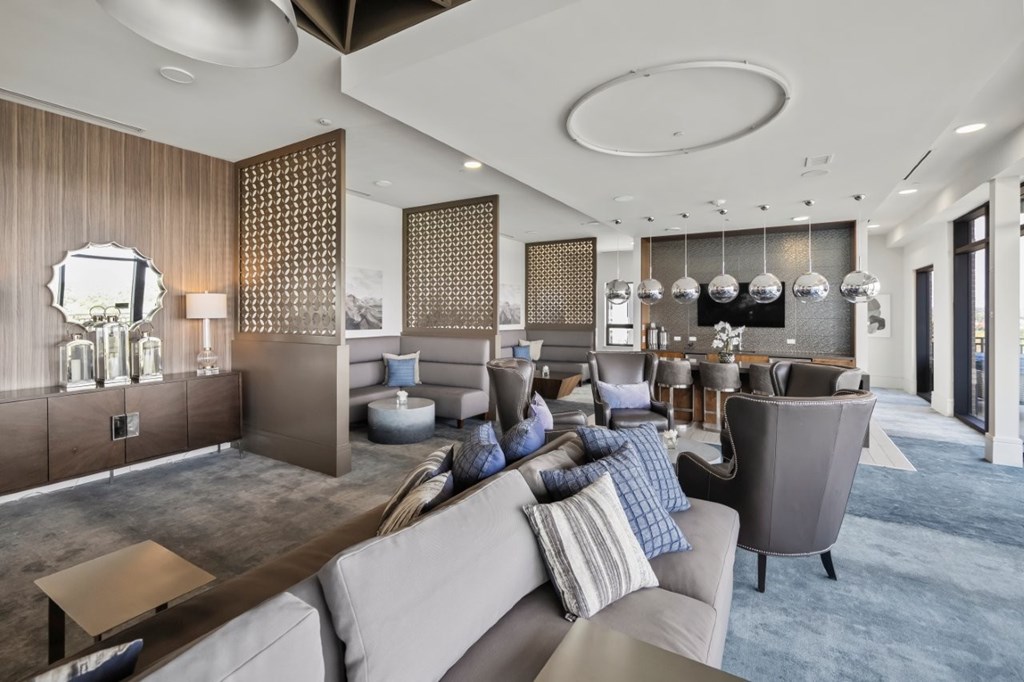 A modern living room with a grey sofa and a wooden coffee table.