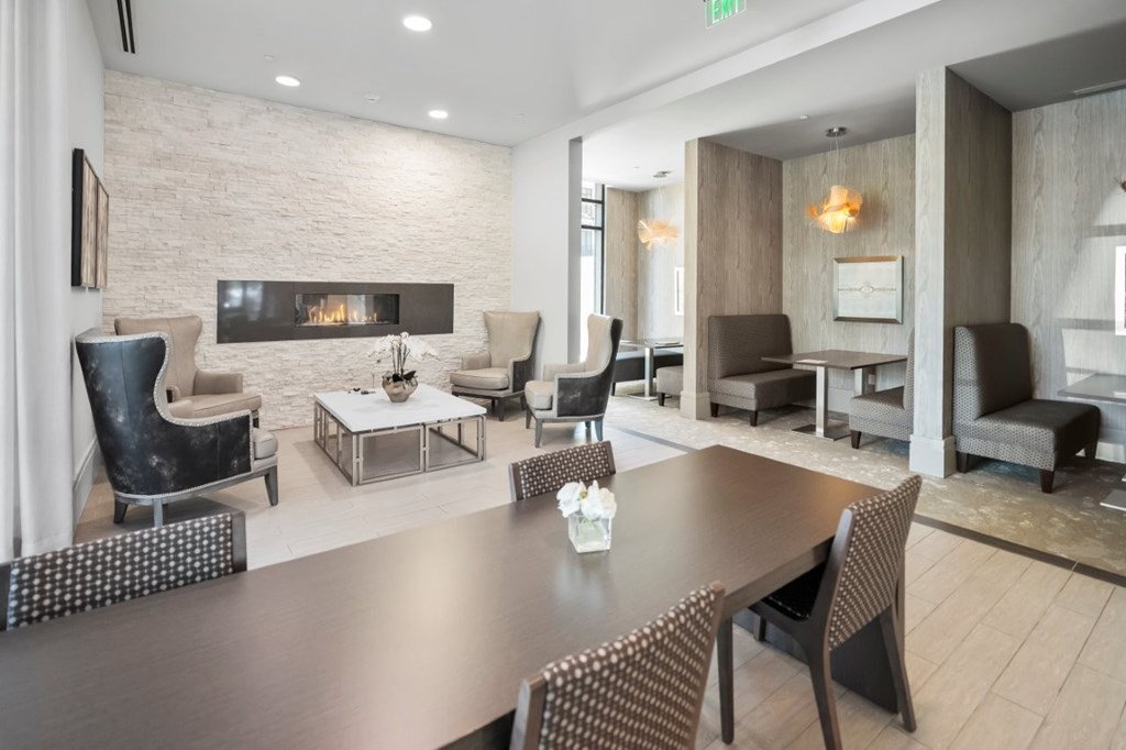 A modern living room with a fireplace and a dining table.