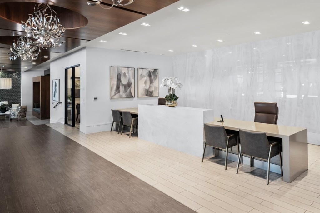 A modern office space with a long table and chairs.