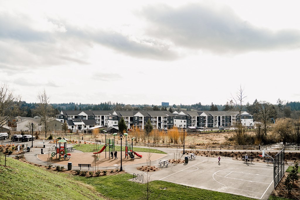 a park with a basketball court and playground