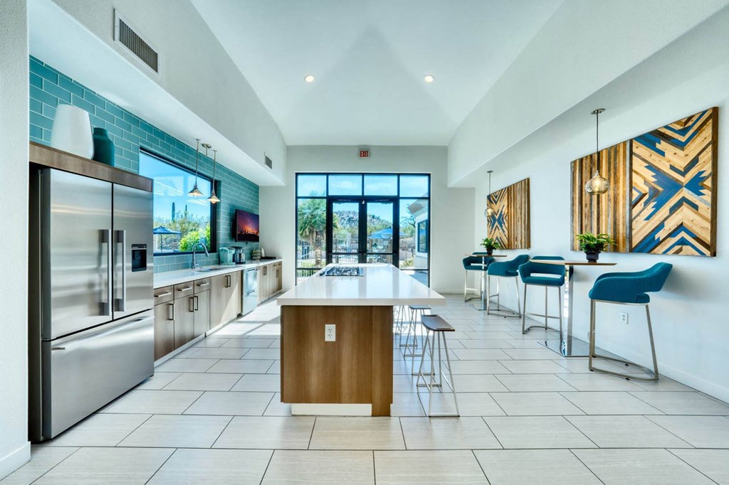 a kitchen with a large center island next to a stove top oven