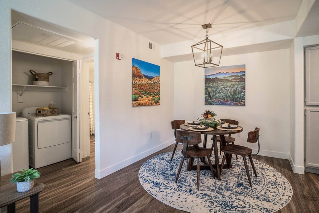 a dining area with a round table and four chairs