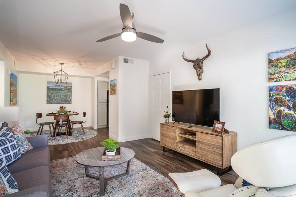 a living room with a couch and a table in front of a tv
