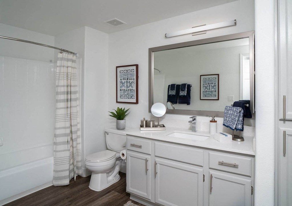 a bathroom with a white toilet next to a white sink