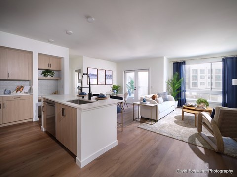 A modern kitchen with wooden cabinets and a white island.