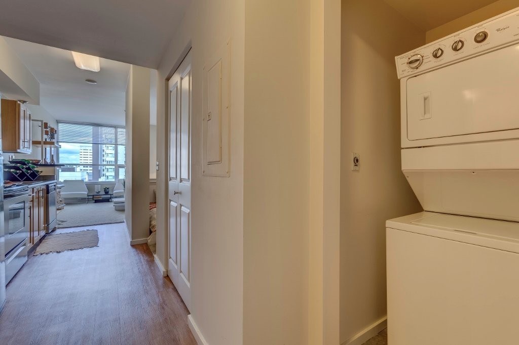 A white oven is in a kitchen with white walls.