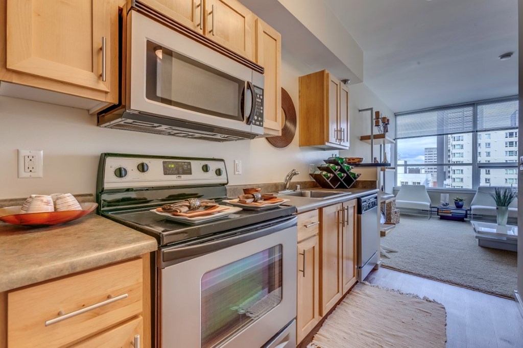 A kitchen with a stove top oven and microwave above it.