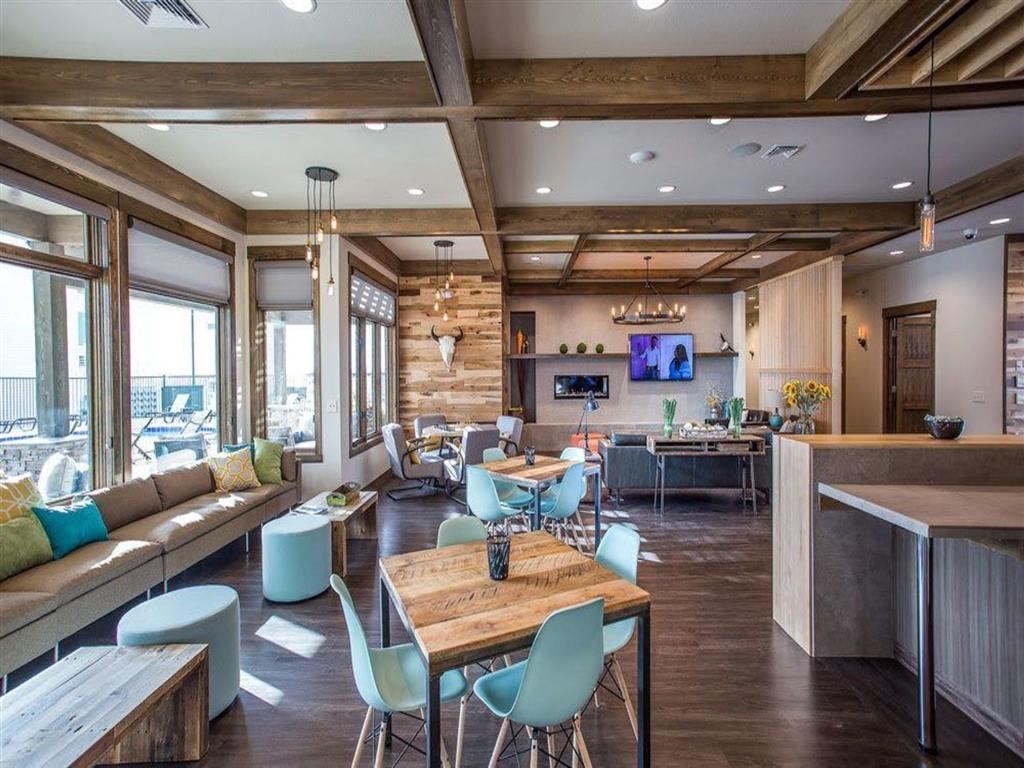 a living room and dining room with furniture and a television