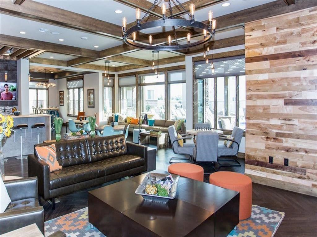 a lobby with couches tables and chairs and a chandelier