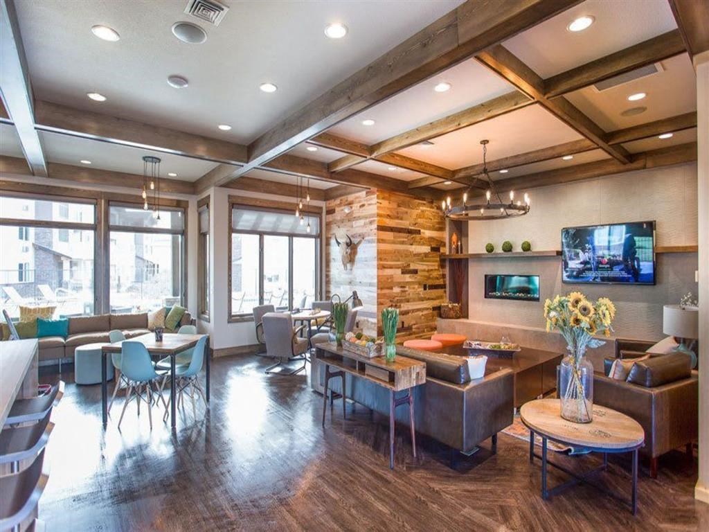 a living room with a television and a table and chairs